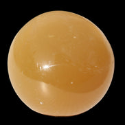 Honey Calcite sphere 47mm 162g in sunlight - Rocks and Things Store
