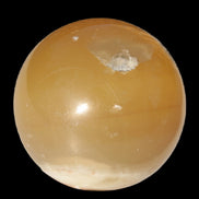 Honey Calcite sphere 47mm 162g in sunlight - Rocks and Things Store