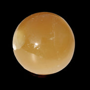 Honey Calcite sphere 47mm 162g in sunlight - Rocks and Things Store