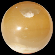 Honey Calcite sphere 47mm 162g in sunlight - Rocks and Things Store