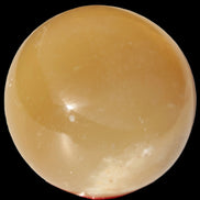 Honey Calcite sphere 47mm 162g in sunlight - Rocks and Things Store