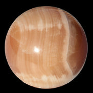 Honey Calcite sphere 49mm 167g in sunlight -  Rocks and Things Store