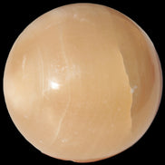 Honey Calcite sphere 49mm 167g in sunlight -  Rocks and Things Store