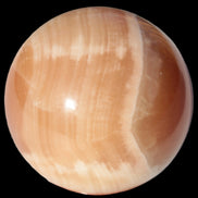 Honey Calcite sphere 49mm 167g in sunlight -  Rocks and Things Store