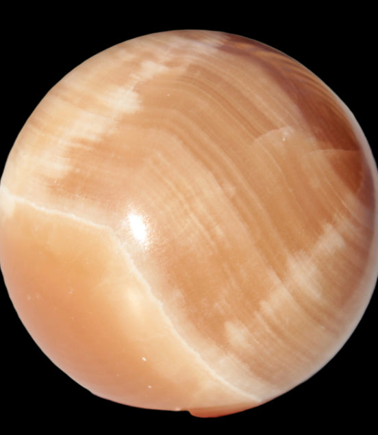 Honey Calcite sphere 53mm 175g in sunlight - Rocks and Things Store