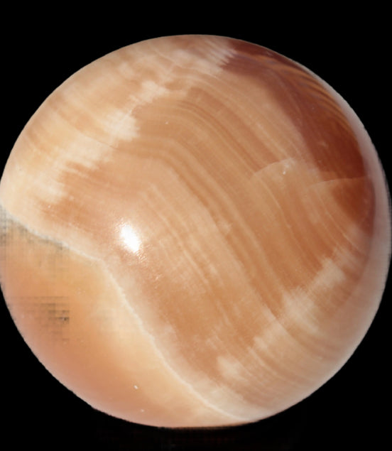 Honey Calcite sphere 53mm 175g in sunlight - Rocks and Things Store