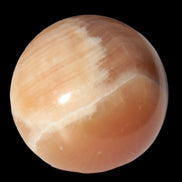 Honey Calcite sphere 53mm 175g in sunlight - Rocks and Things Store