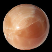Honey Calcite sphere 53mm 175g in sunlight - Rocks and Things Store
