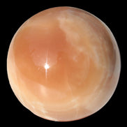 Honey Calcite sphere 53mm 175g in sunlight - Rocks and Things Store