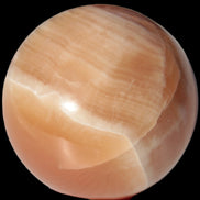 Honey Calcite sphere 53mm 175g in sunlight - Rocks and Things Store