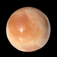 Honey Calcite sphere 53mm 175g in sunlight - Rocks and Things Store