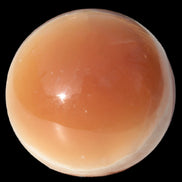 Honey Calcite sphere 53mm 175g in sunlight - Rocks and Things Store