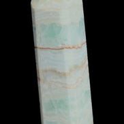 Pistachio Calcite obelisk 131*37*30mm 324g in sunlight - Rocks and Things Store
