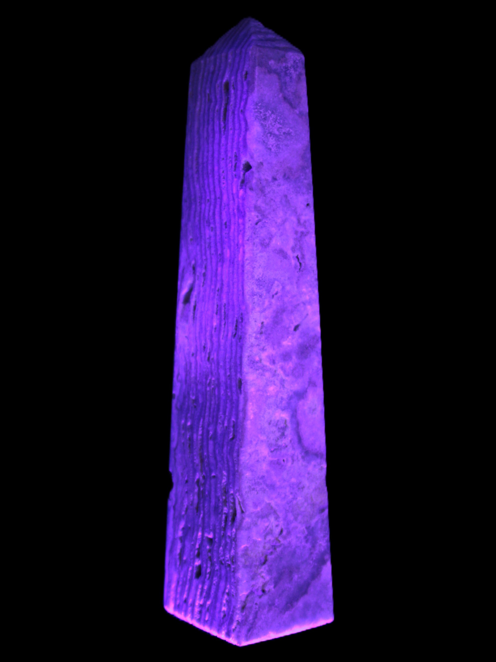 Caribbean Calcite obelisk 95*40*44mm 571g in UV light - Rocks and Things Store