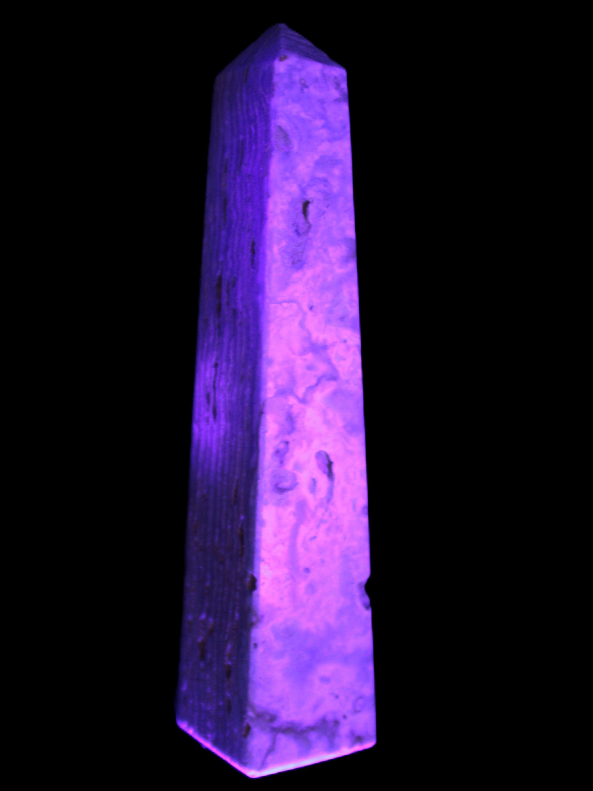 Caribbean Calcite obelisk 95*40*44mm 571g in UV light - Rocks and Things Store