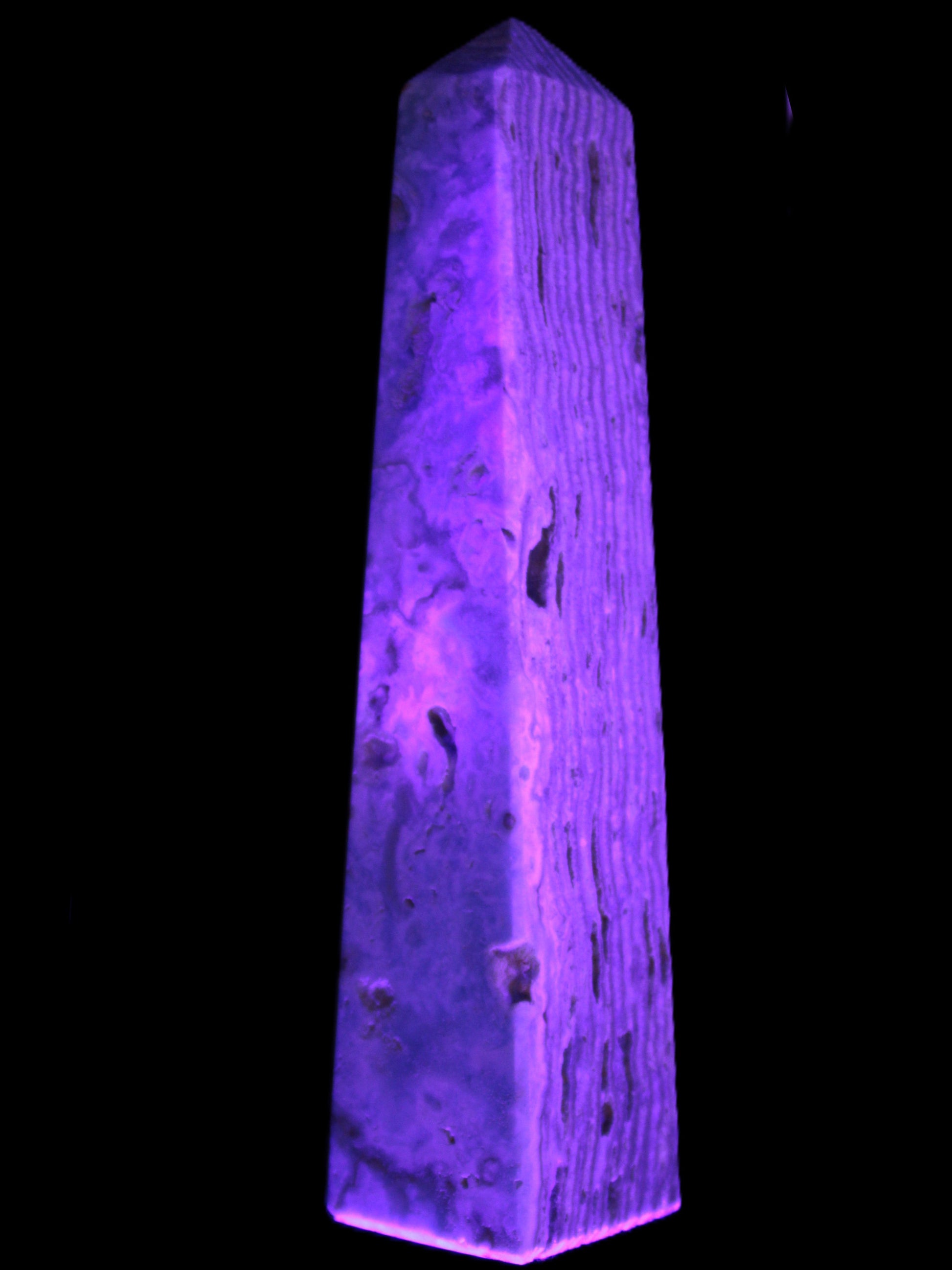 Caribbean Calcite obelisk 95*40*44mm 571g in UV light - Rocks and Things Store