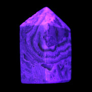 Caribbean Calcite obelisk 55*26*29mm 94g in UV light -  Rocks and Things Store
