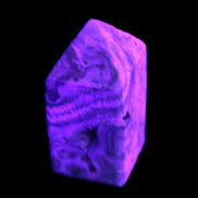 Caribbean Calcite obelisk 55*26*29mm 94g in UV light -  Rocks and Things Store