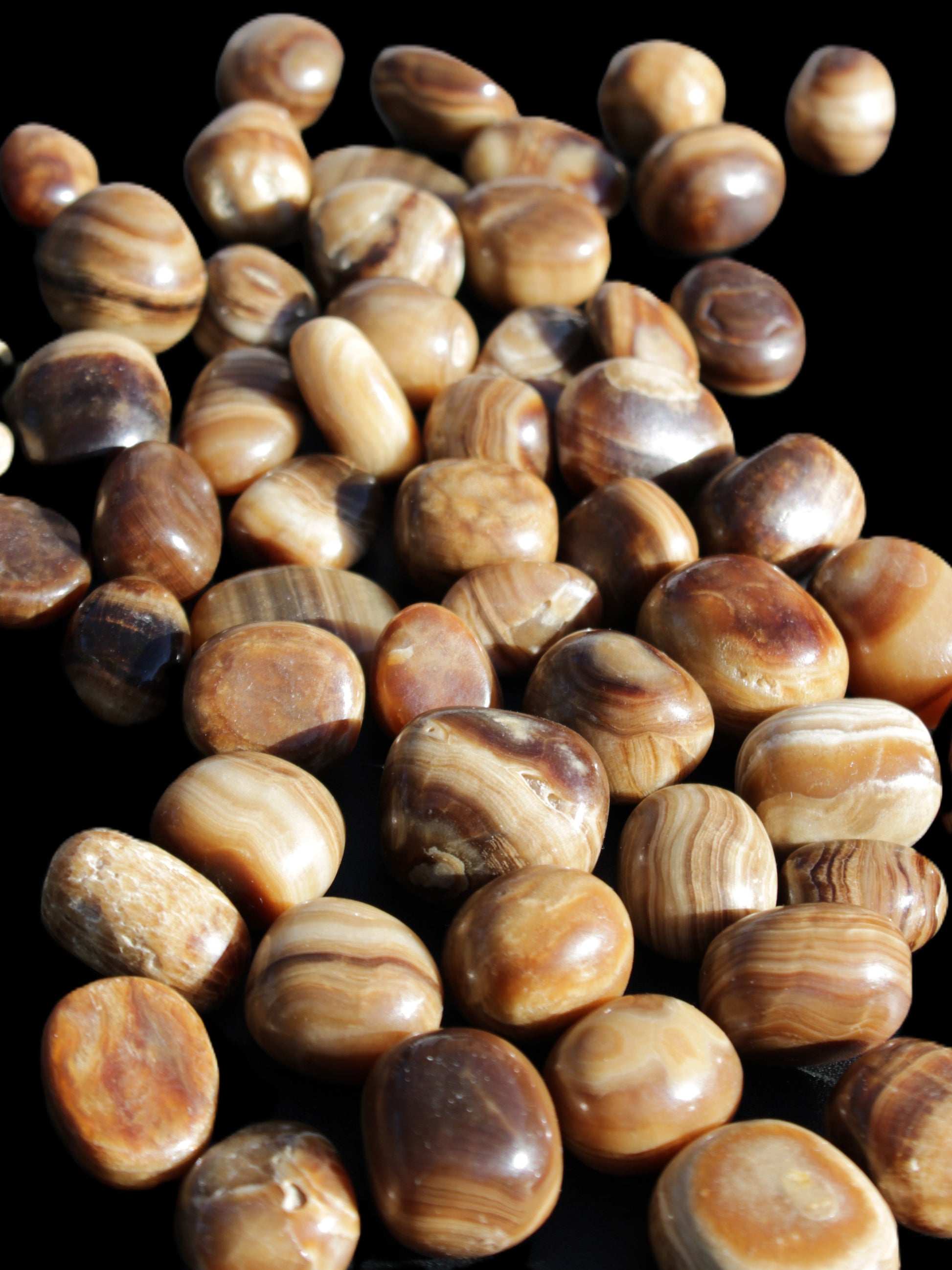 Chocolate Calcite 55 tumbled stones 21*11mm - 24-23mm  810g Wholesale in sunlight - Rocks and Things Store