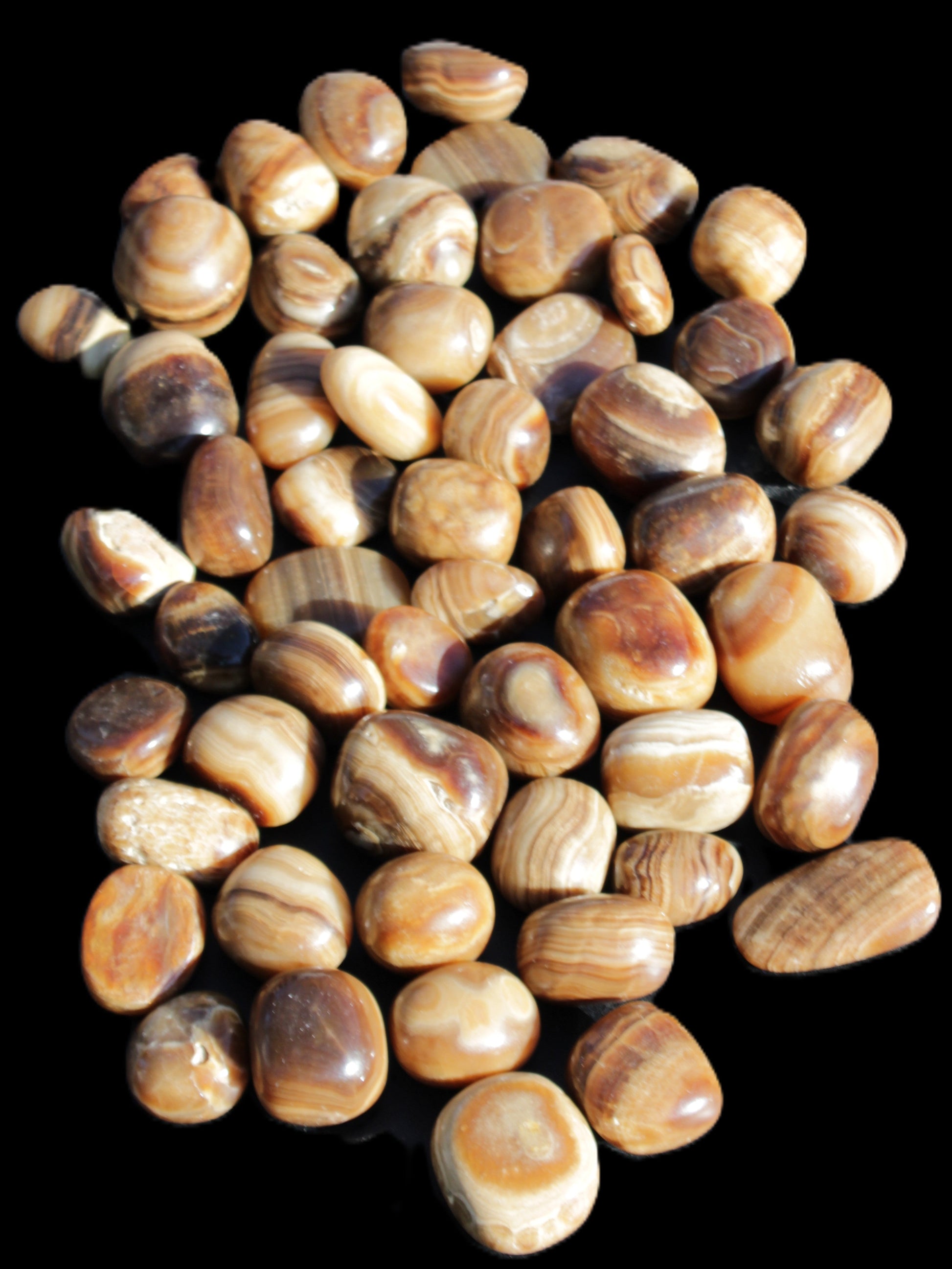 Chocolate Calcite 55 tumbled stones 21*11mm - 24-23mm  810g Wholesale in sunlight - Rocks and Things Store