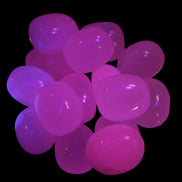 Mangano Calcite UV bright-pink-reactive tumbled stone 7-8g  in UV light - Rocks and Things Store