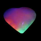 Calcite dyed and UV reactive hand-carved heart 89g in UV light - Rocks and Things Store