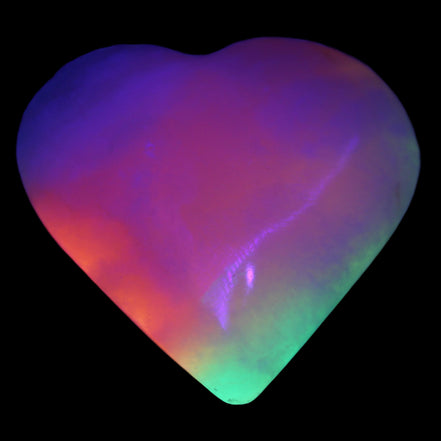 Calcite dyed and UV reactive hand-carved heart 89g in UV light - Rocks and Things Store