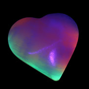Calcite dyed and UV reactive hand-carved heart 89g in UV light - Rocks and Things Store