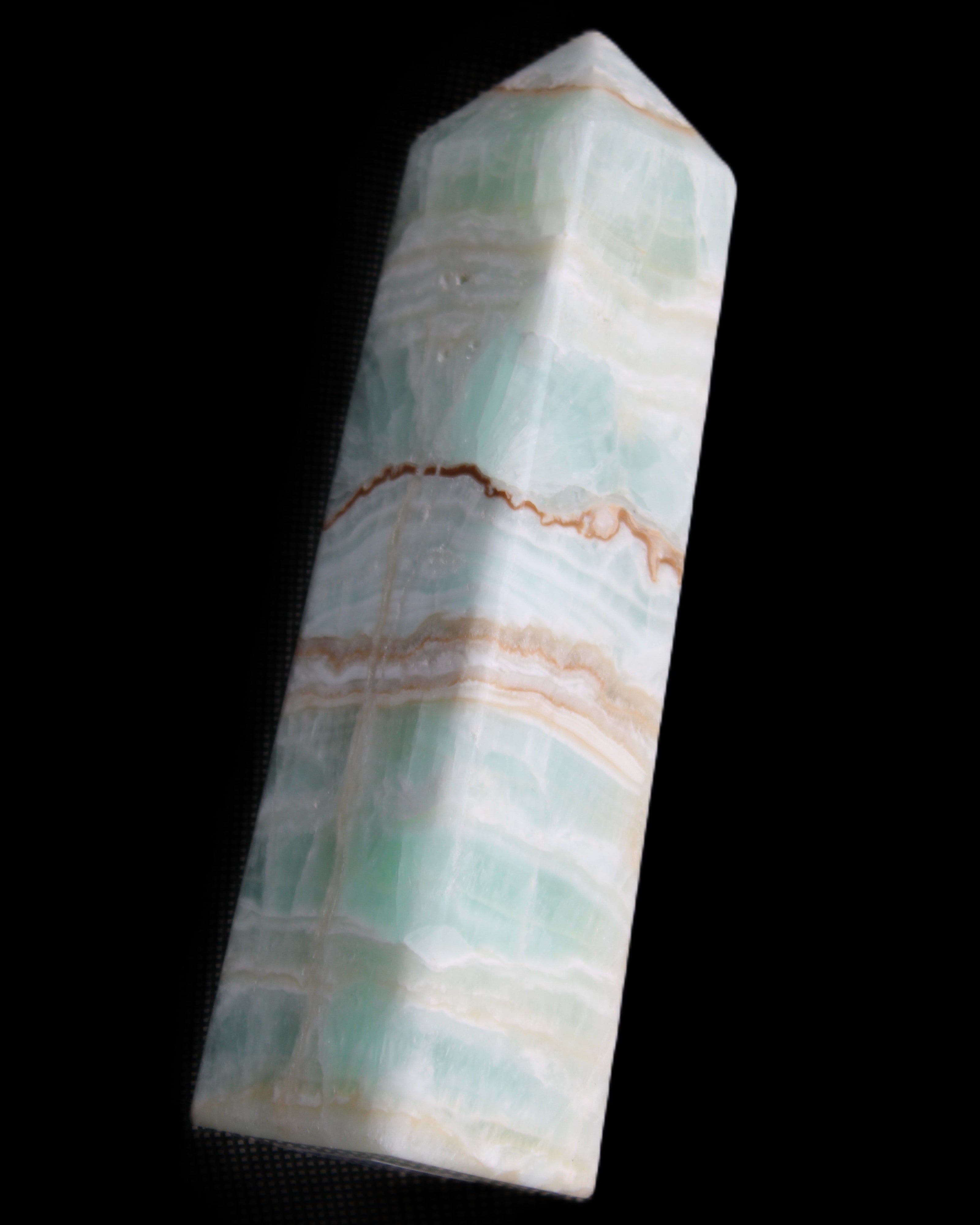Pistachio Calcite obelisk 134mm 346g in sunlight - Rocks and Things Store