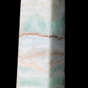 Pistachio Calcite obelisk 134mm 346g in sunlight - Rocks and Things Store