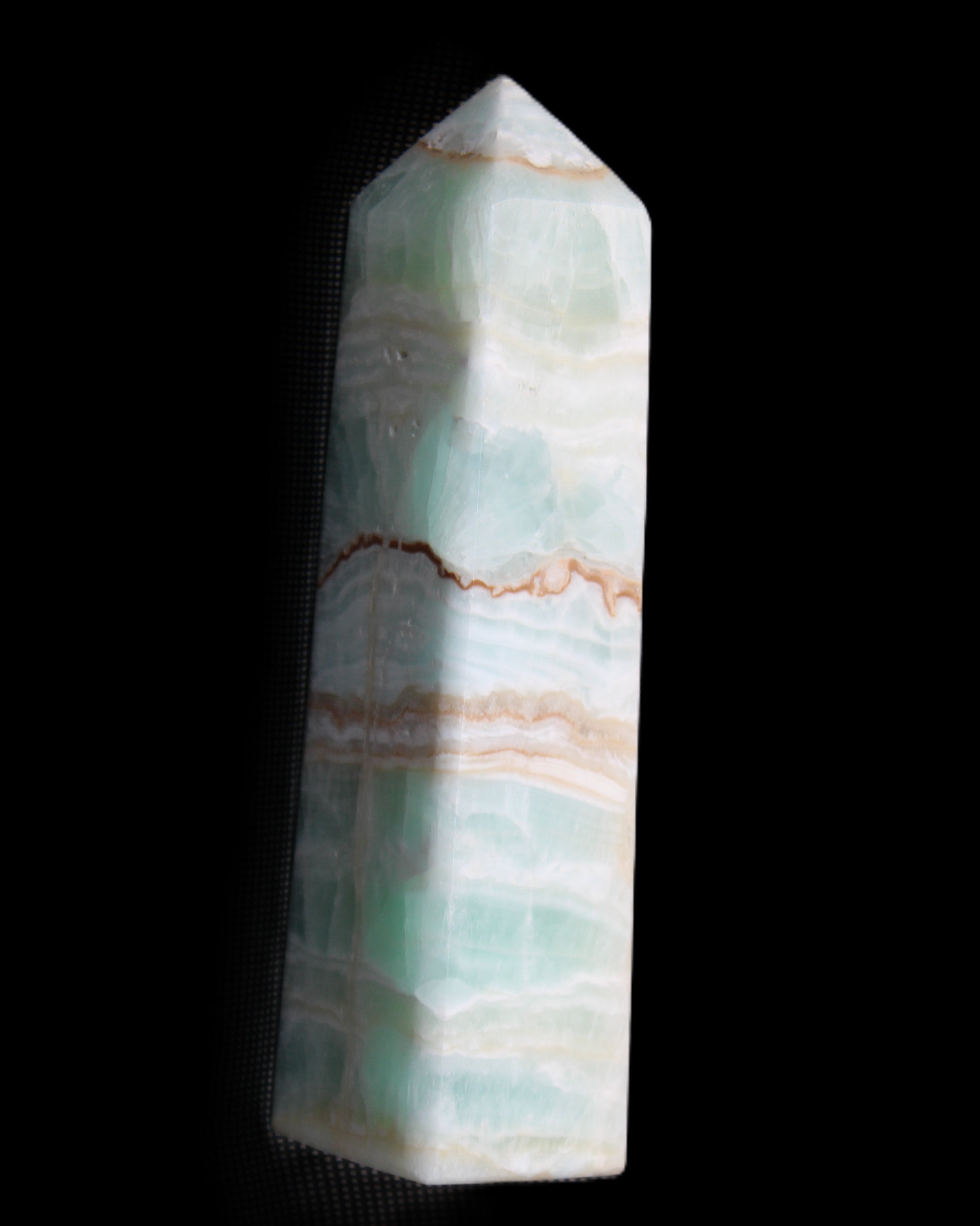 Pistachio Calcite obelisk 134mm 346g in sunlight - Rocks and Things Store
