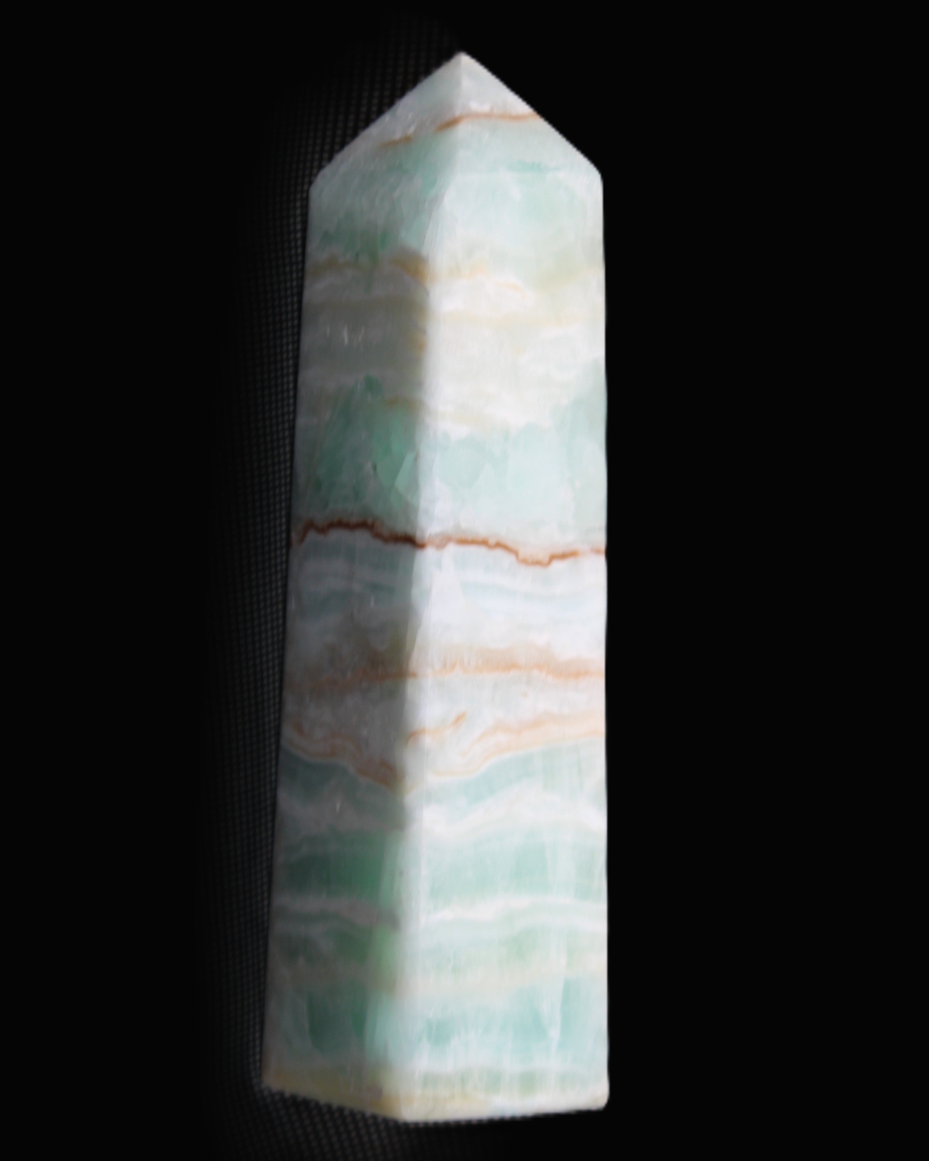 Pistachio Calcite obelisk 134mm 346g in sunlight - Rocks and Things Store