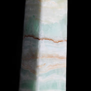 Pistachio Calcite obelisk 134mm 346g in sunlight - Rocks and Things Store