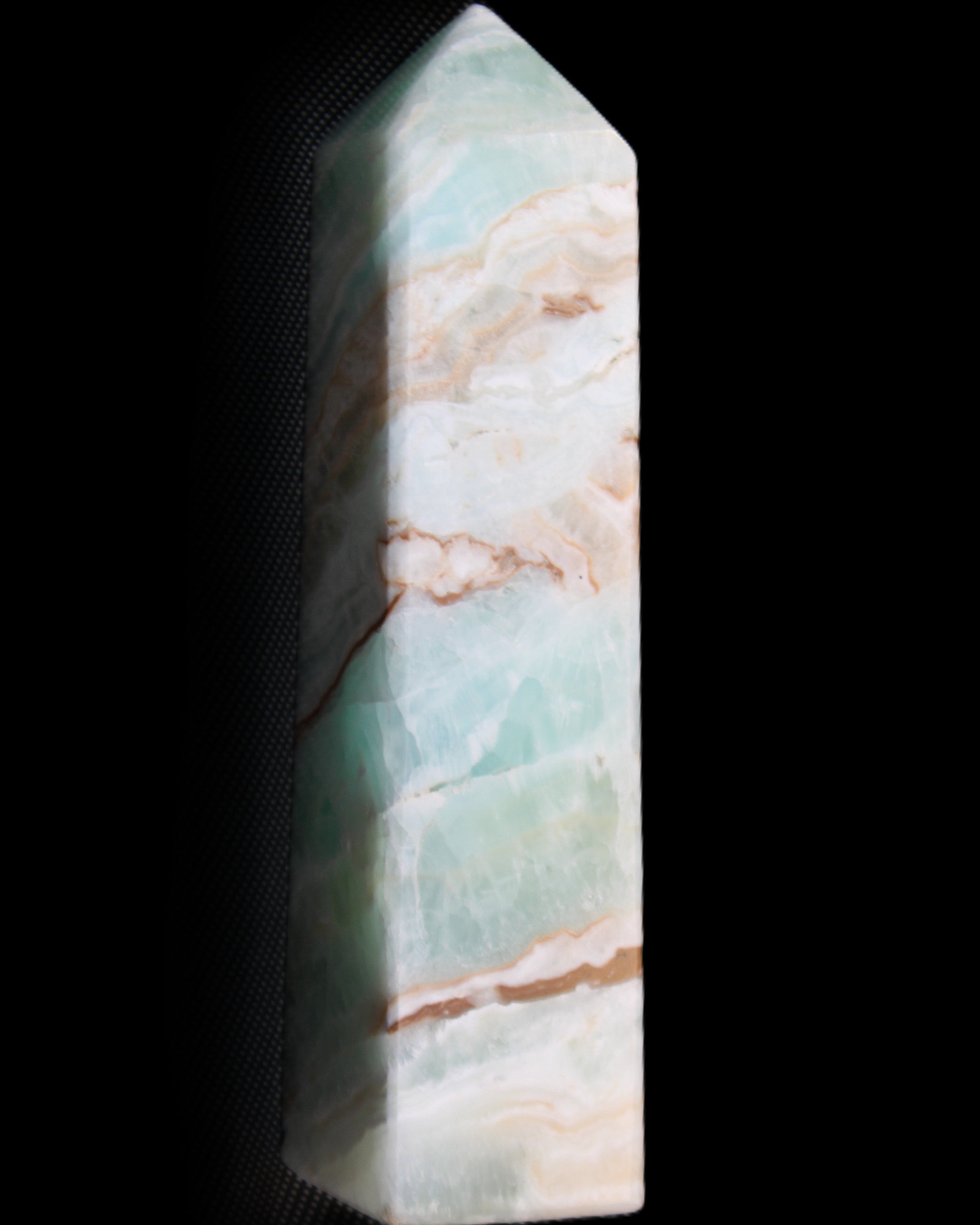 Pistachio Calcite obelisk 147mm 419g in sunlight - Rocks and Things Store