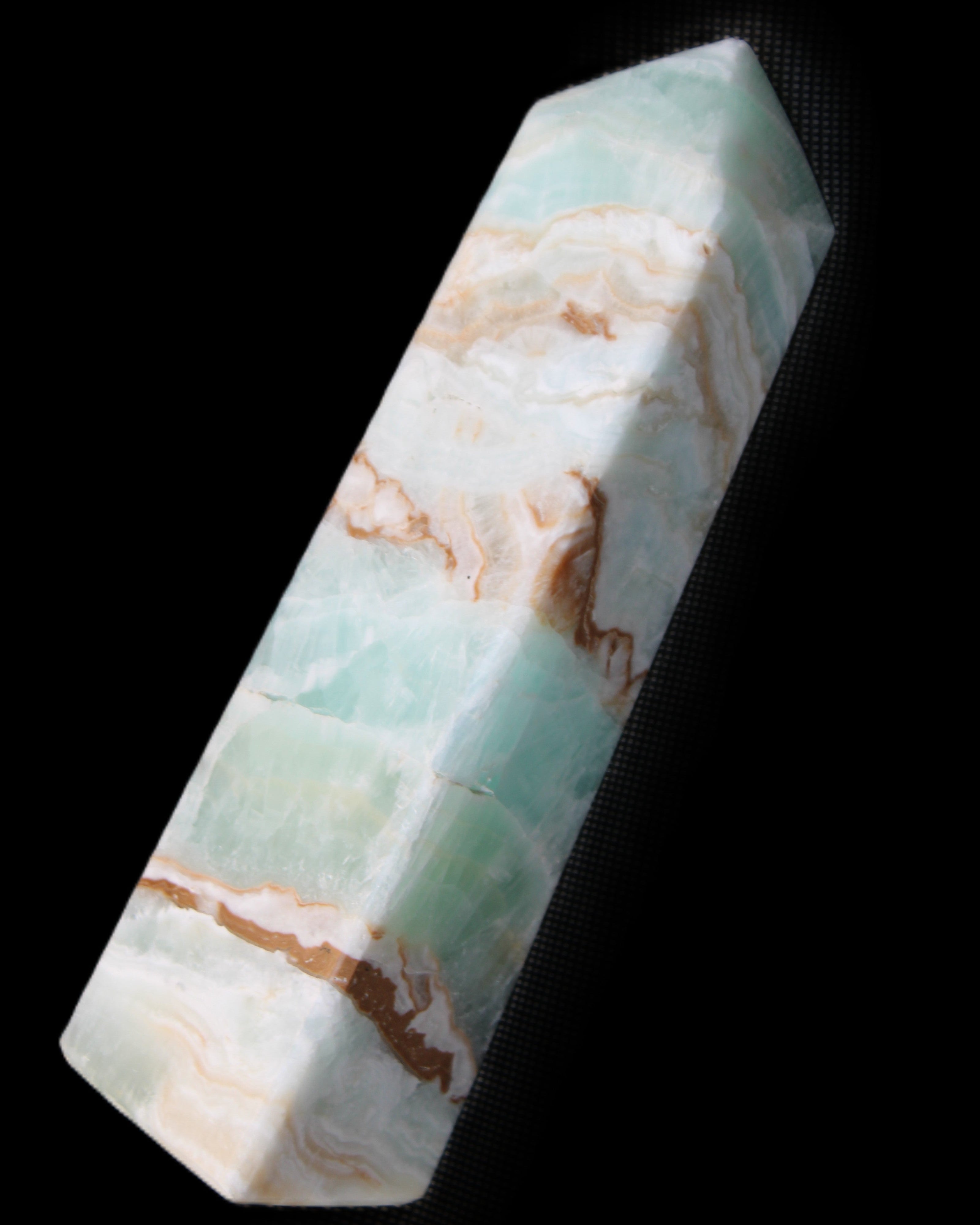Pistachio Calcite obelisk 147mm 419g in sunlight - Rocks and Things Store