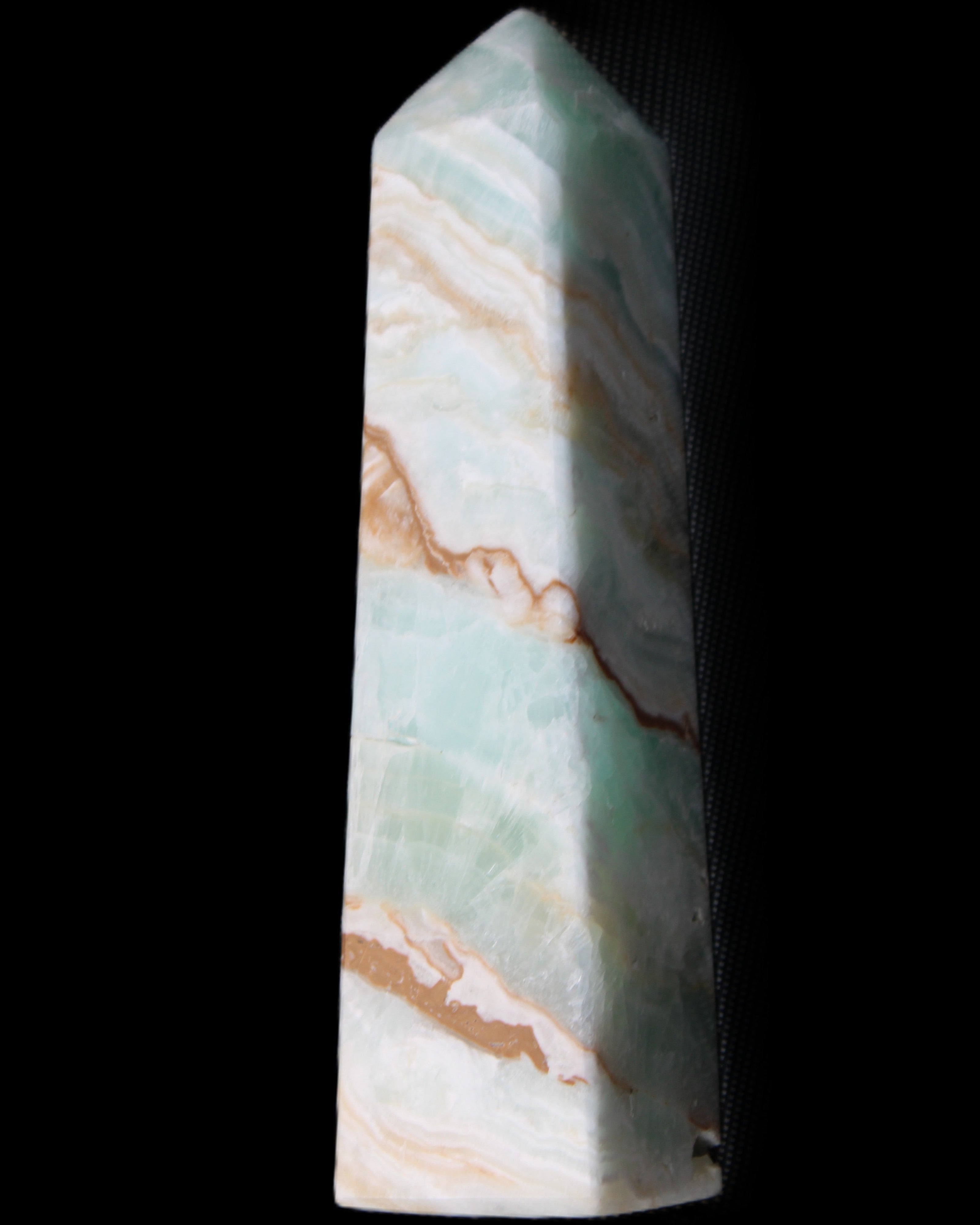 Pistachio Calcite obelisk 147mm 419g in sunlight - Rocks and Things Store