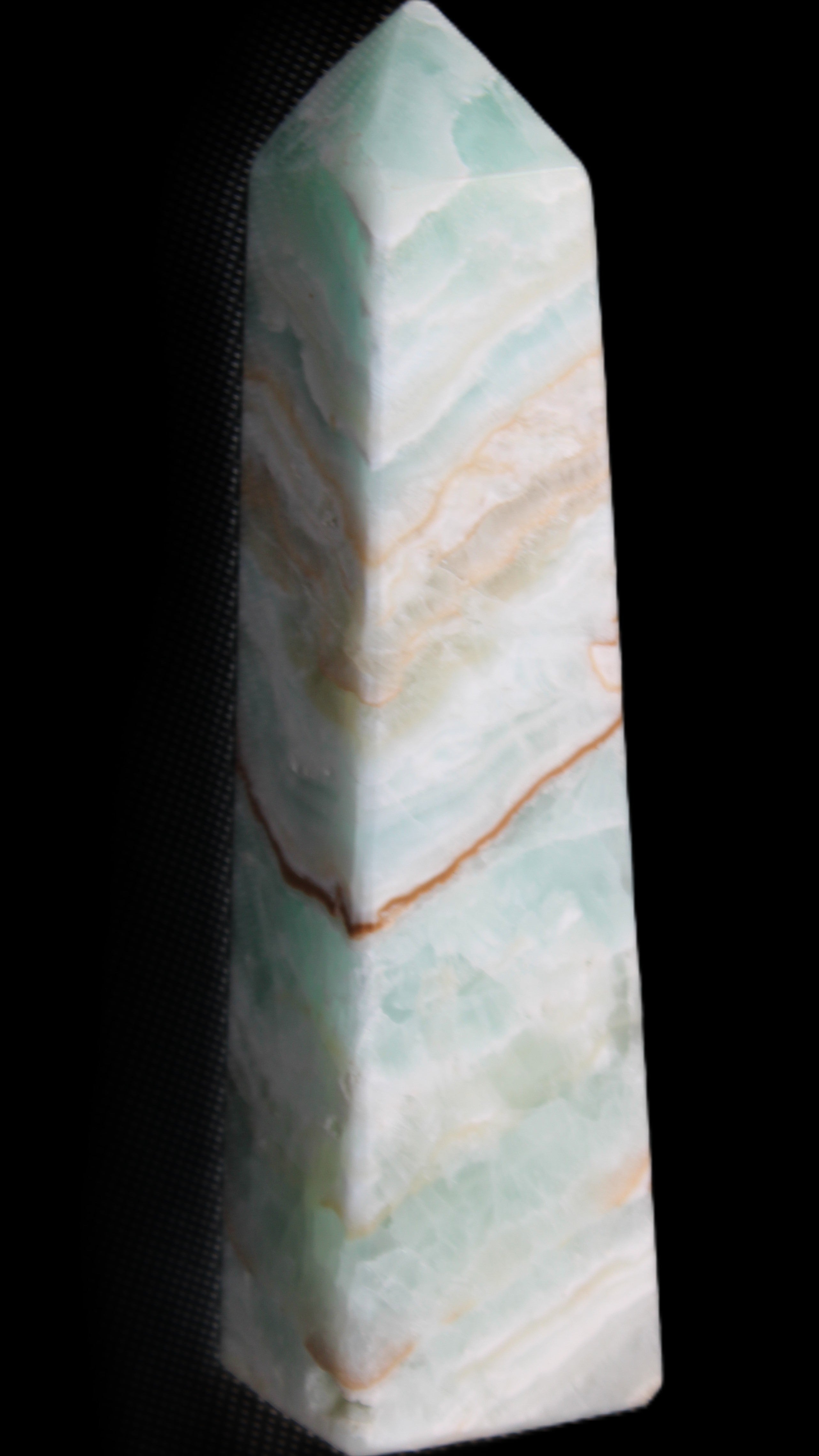 Pistachio Calcite obelisk 147mm 419g in sunlight - Rocks and Things Store