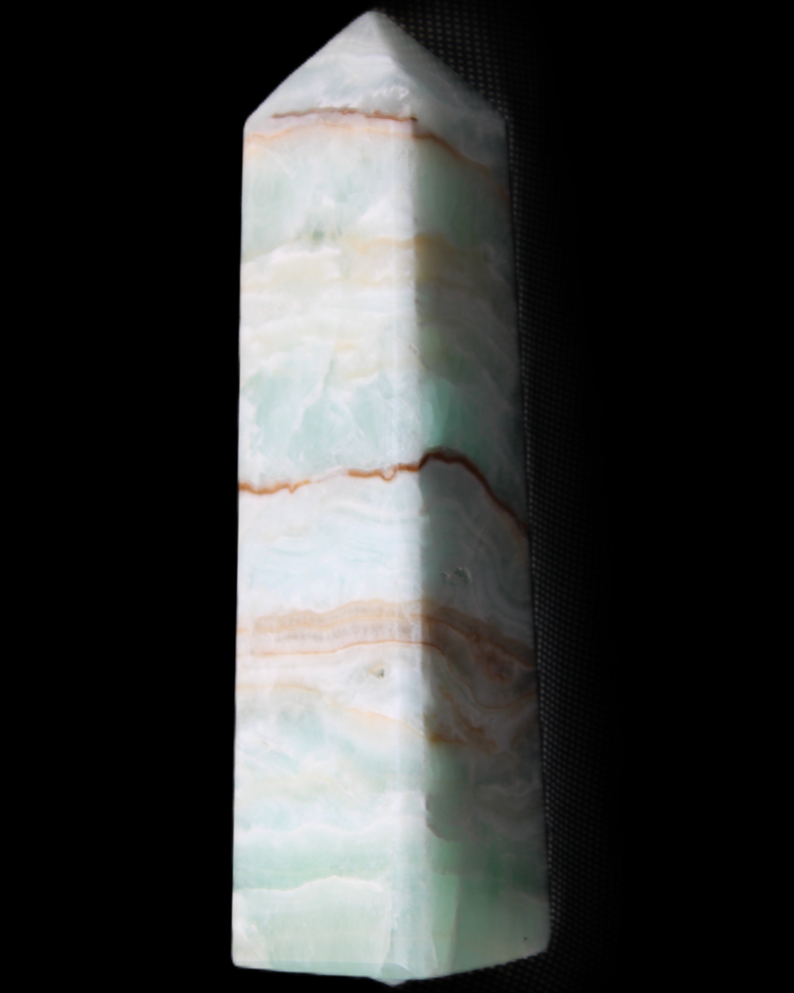 Pistachio Calcite obelisk 134mm 339g in sunlight - Rocks and Things Store