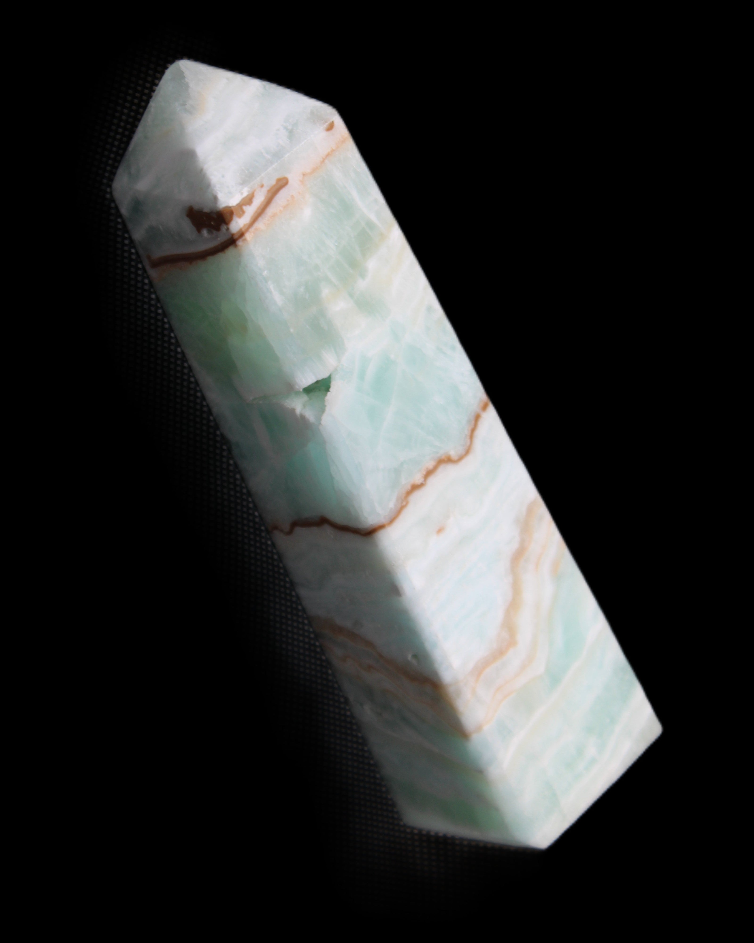 Pistachio Calcite obelisk 134mm 339g in sunlight - Rocks and Things Store