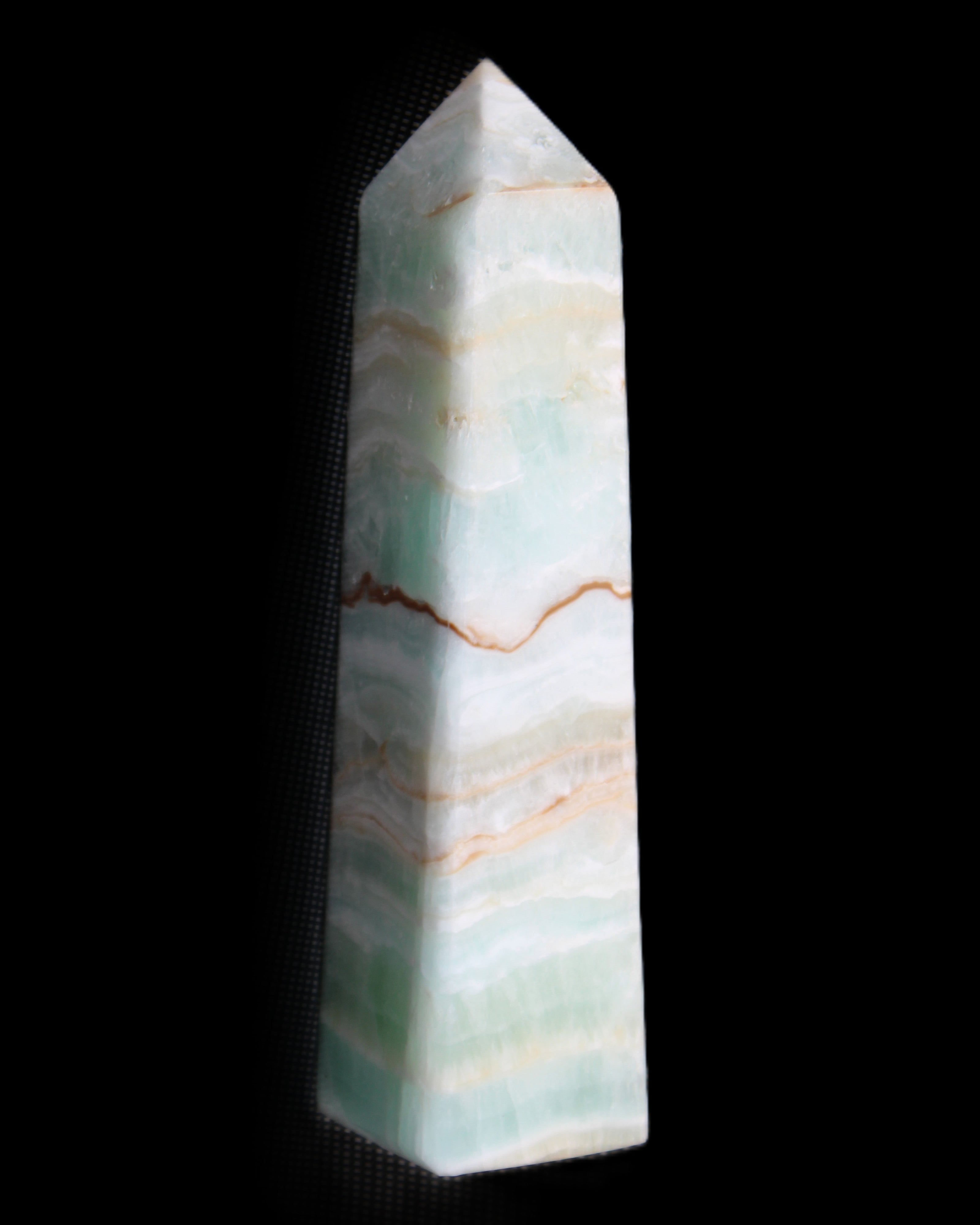 Pistachio Calcite obelisk 132mm 304g in sunlight - Rocks and Things Store