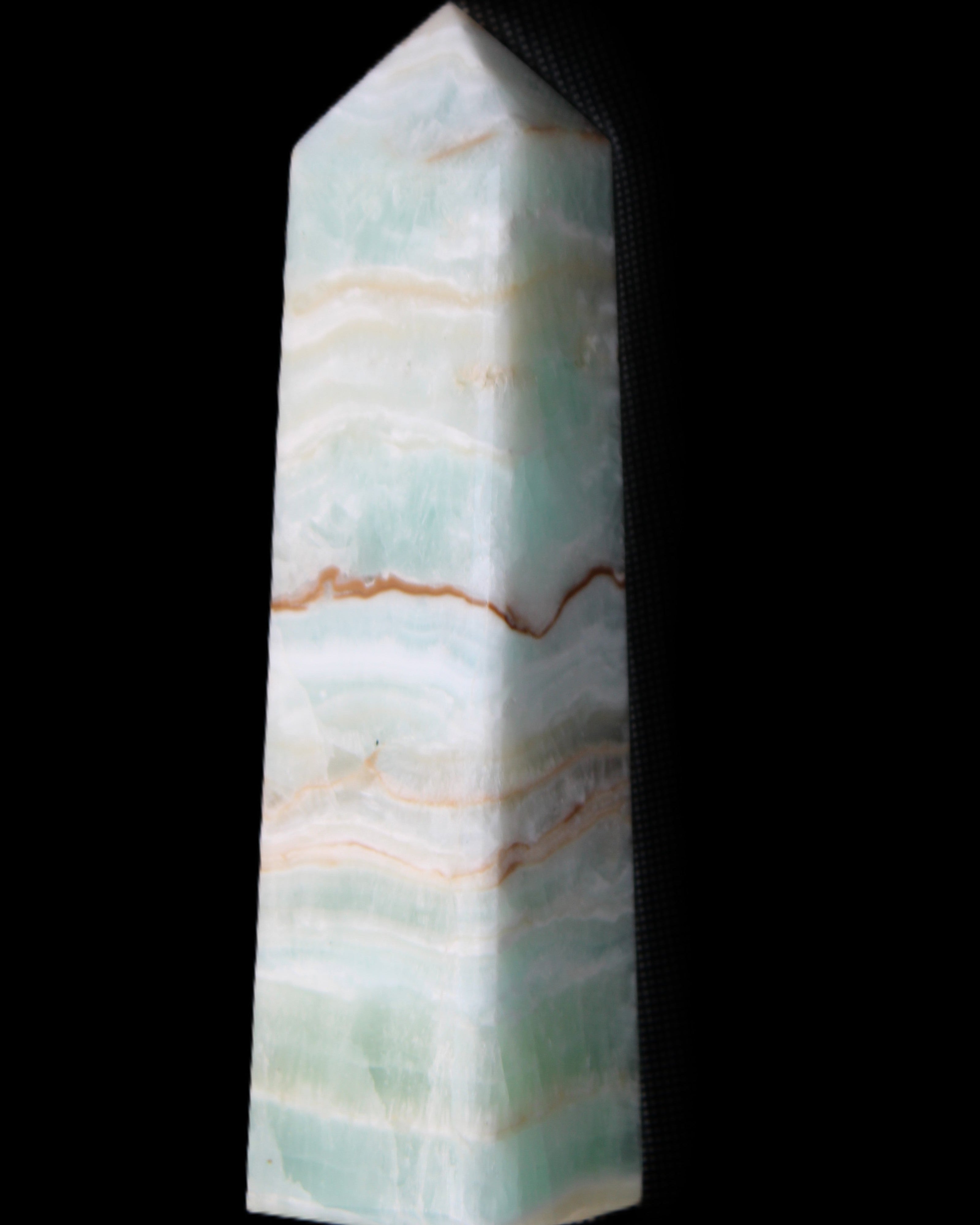 Pistachio Calcite obelisk 132mm 304g in sunlight - Rocks and Things Store