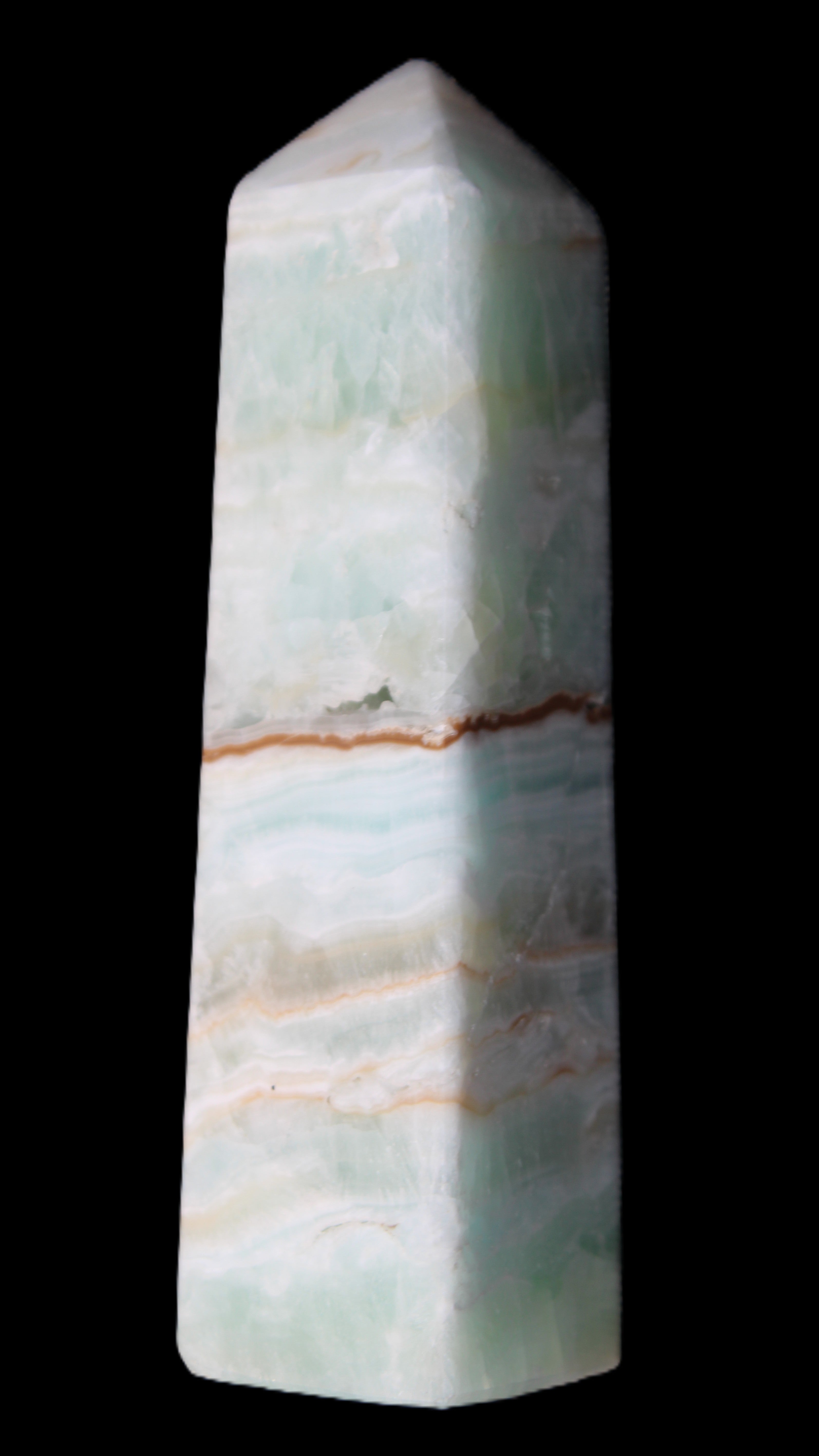 Pistachio Calcite obelisk 122mm 290g in sunlight - Rocks and Things Store