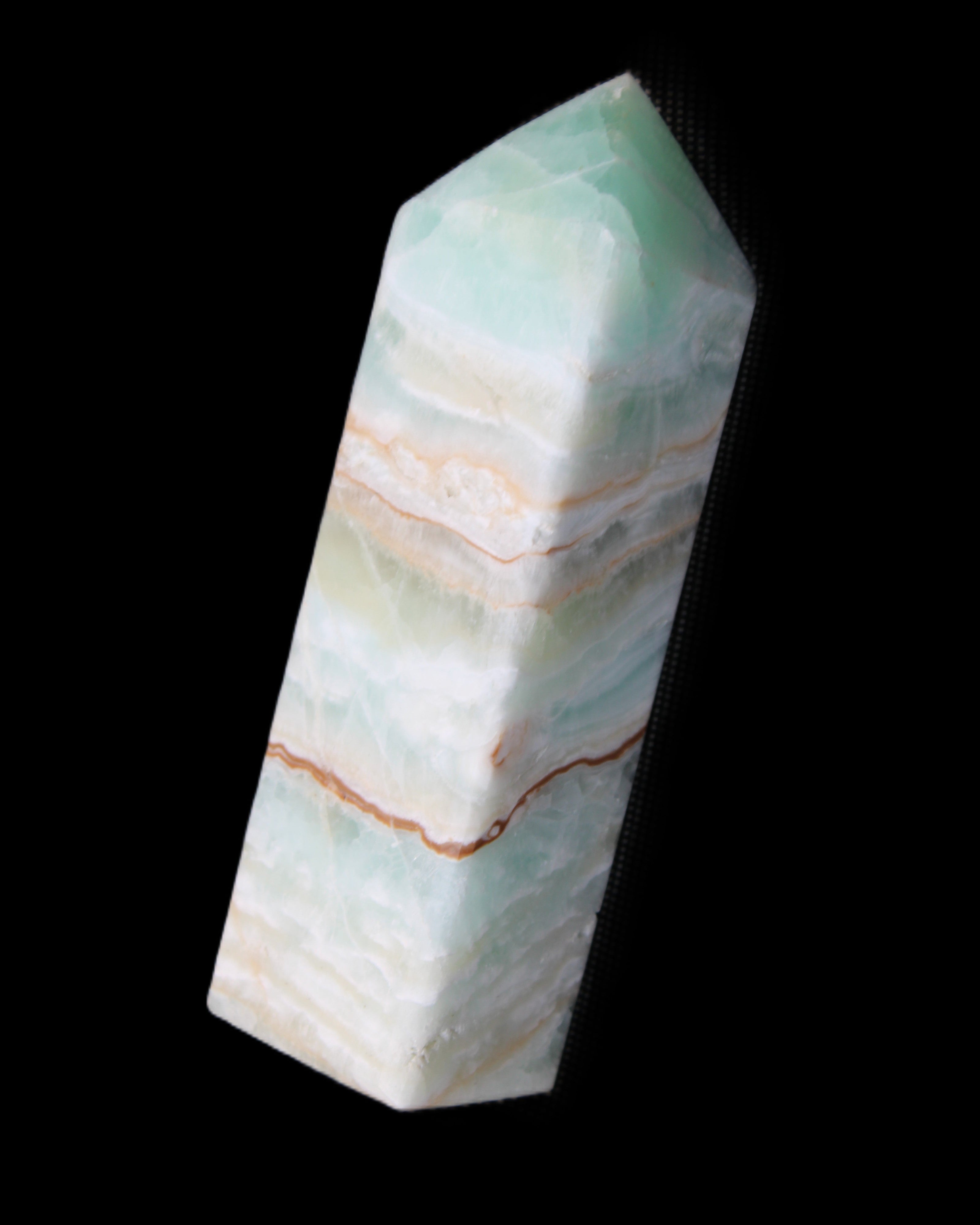 Pistachio Calcite obelisk 120mm 300g in sunlight - Rocks and Things Store