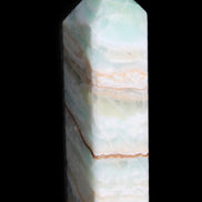 Pistachio Calcite obelisk 120mm 300g in sunlight - Rocks and Things Store