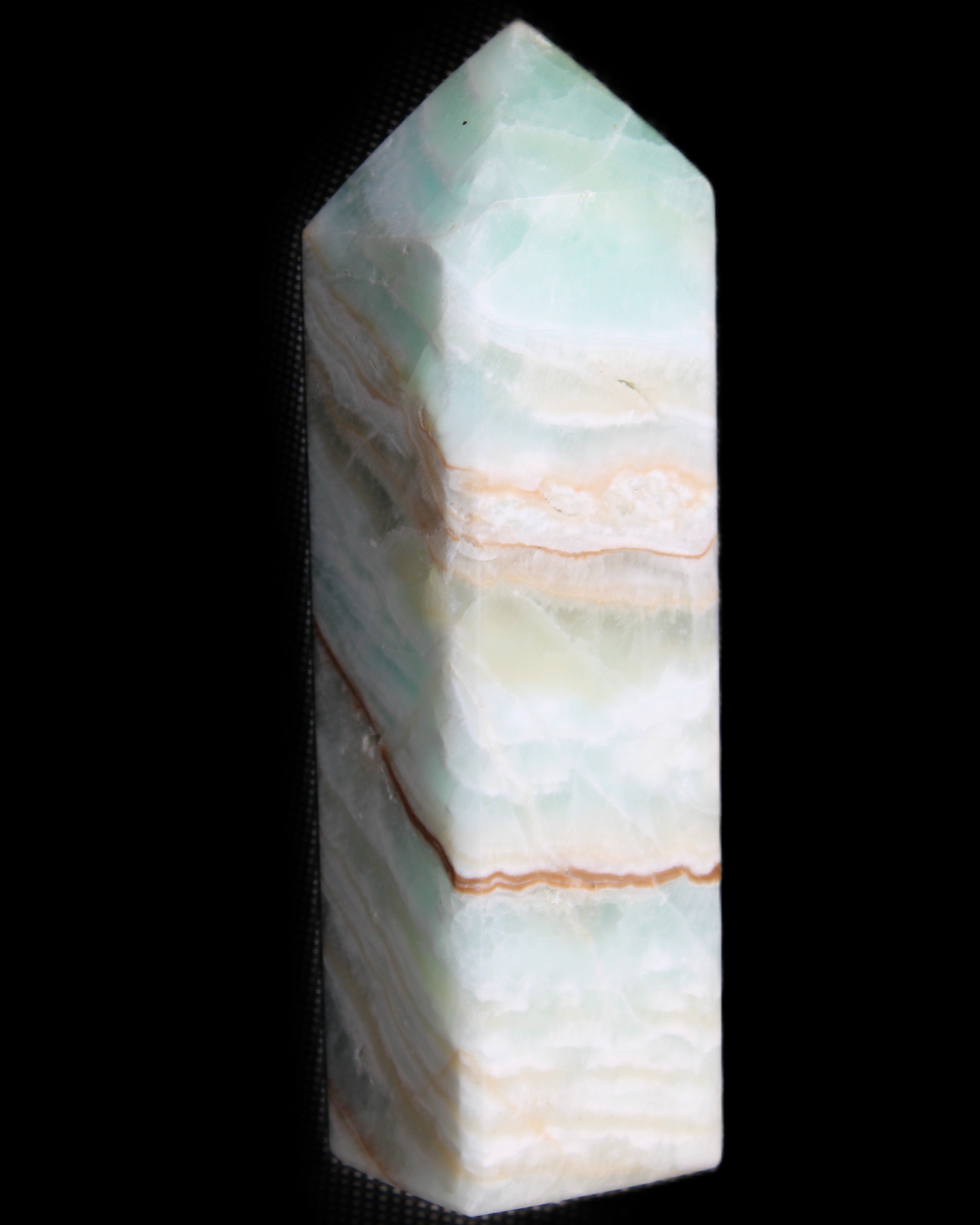 Pistachio Calcite obelisk 120mm 300g in sunlight - Rocks and Things Store