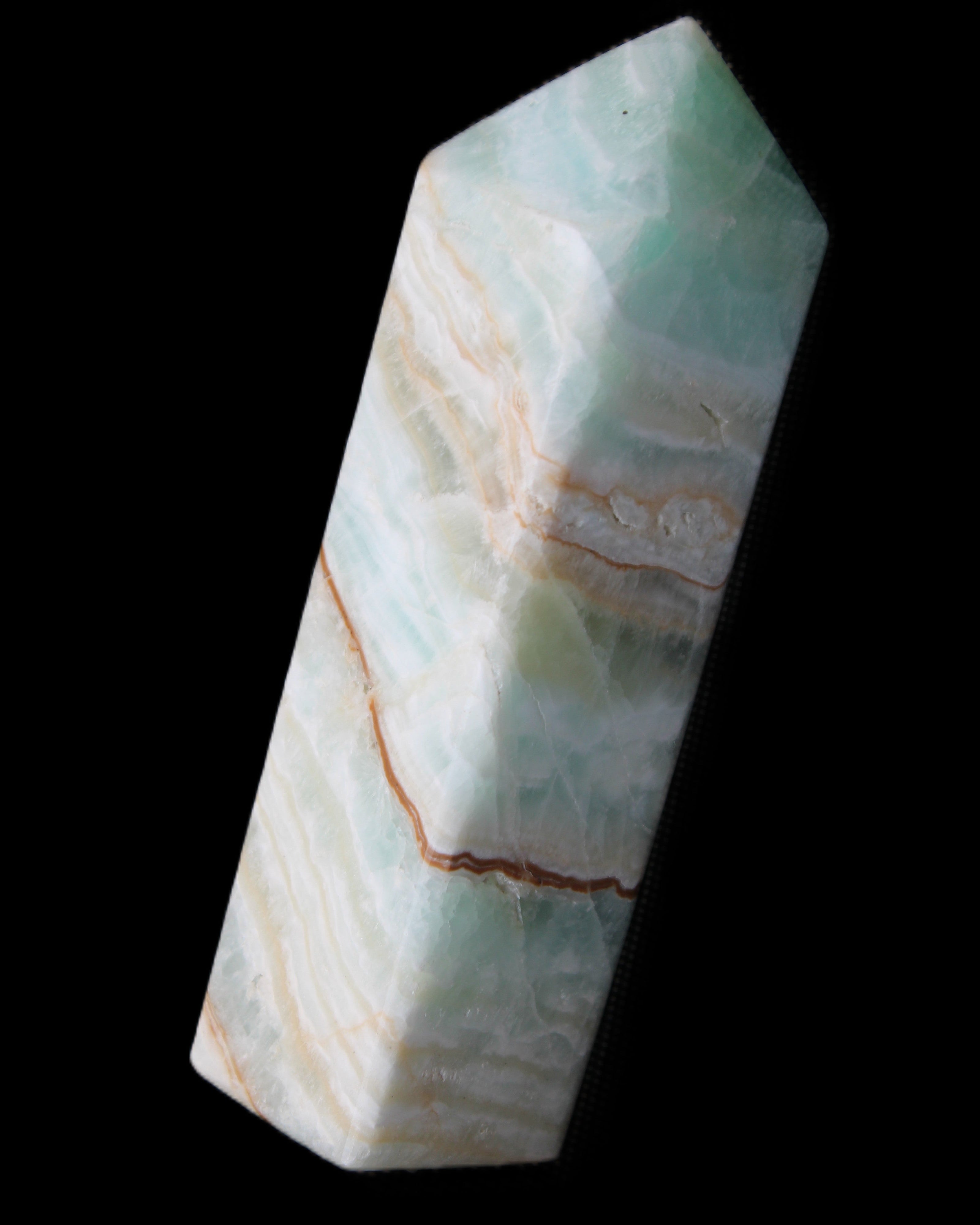 Pistachio Calcite obelisk 120mm 300g in sunlight - Rocks and Things Store