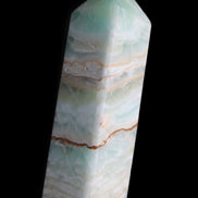 Pistachio Calcite obelisk 120mm 300g in sunlight - Rocks and Things Store