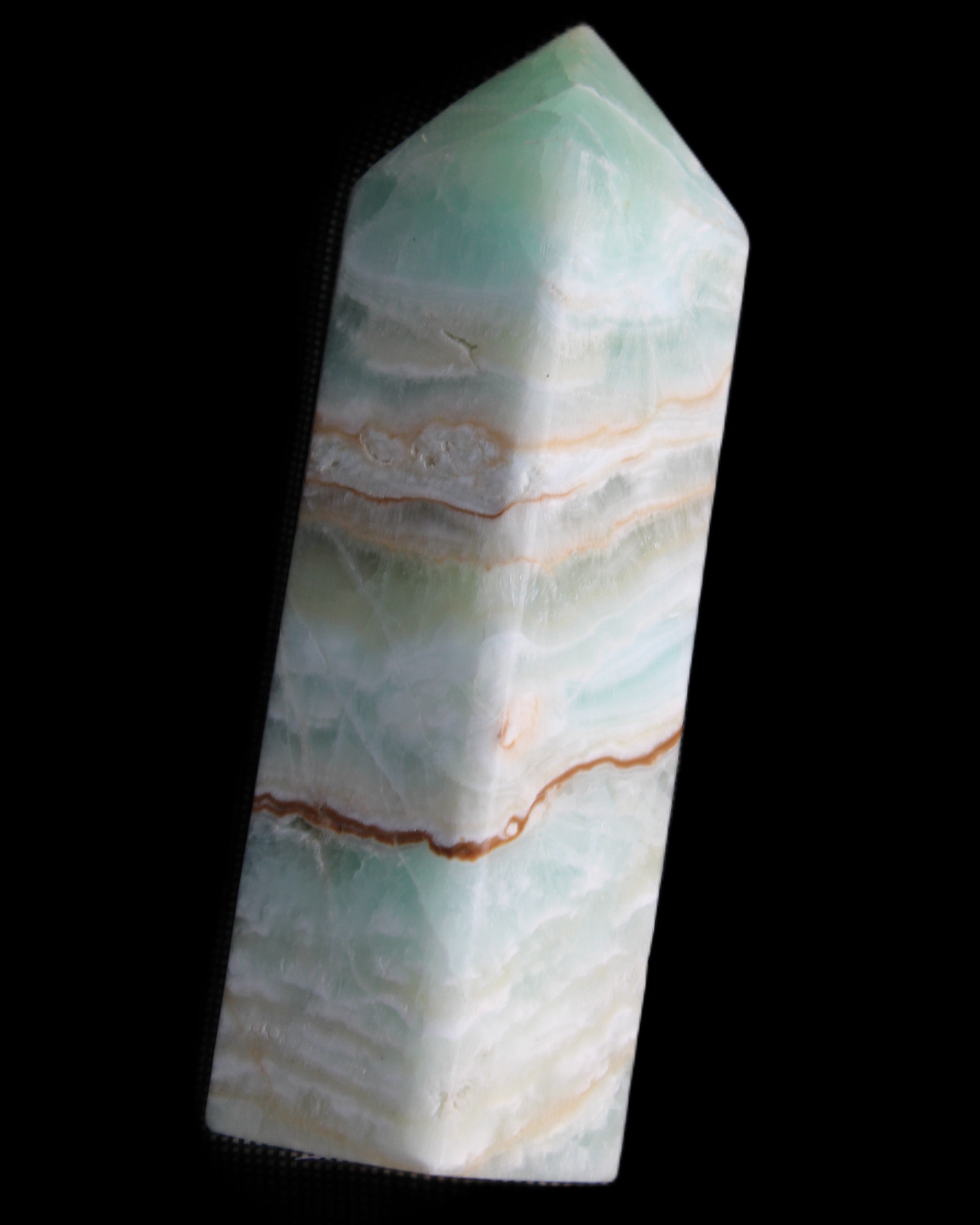 Pistachio Calcite obelisk 120mm 300g in sunlight - Rocks and Things Store