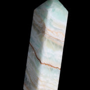 Pistachio Calcite obelisk 120mm 300g in sunlight - Rocks and Things Store