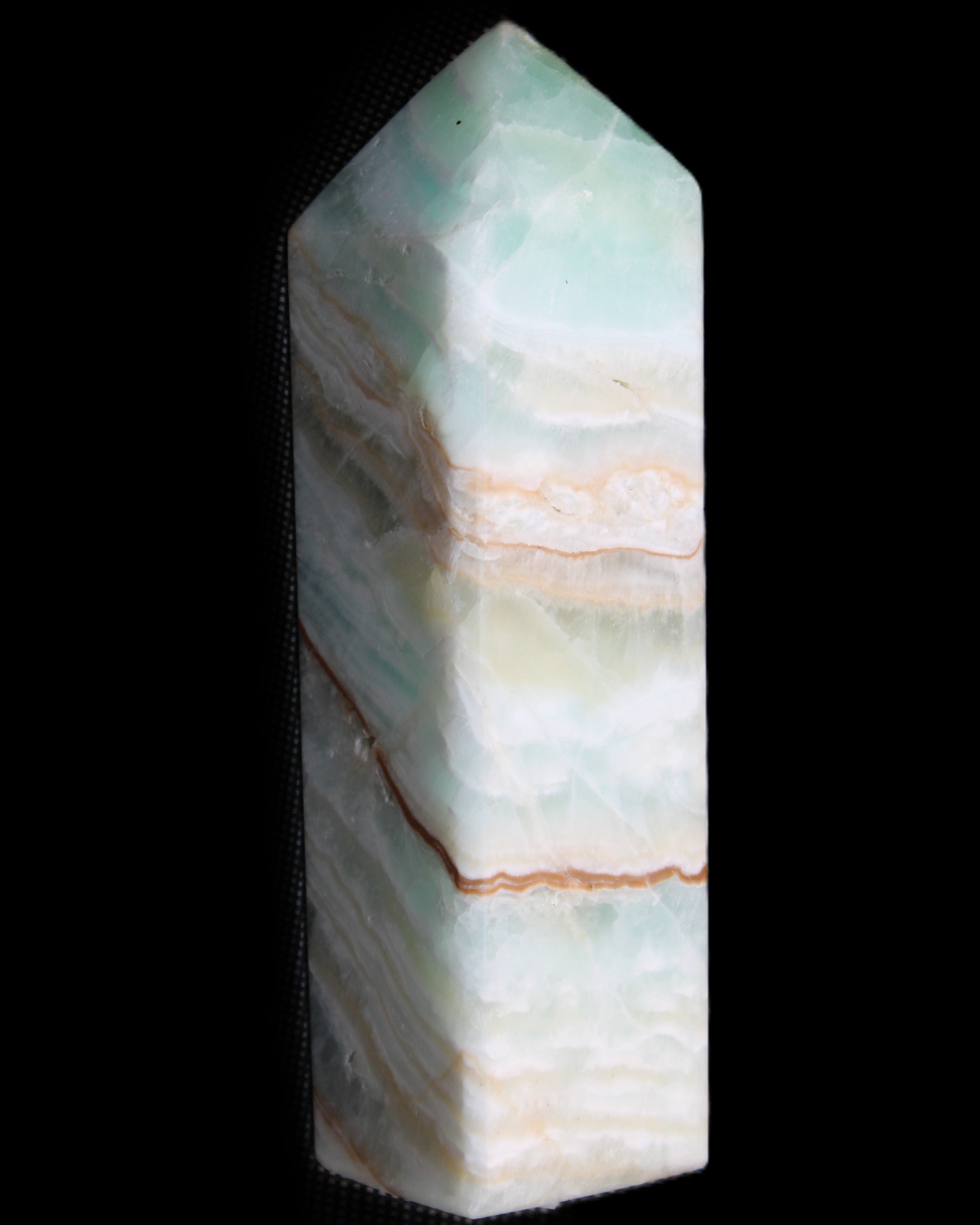 Pistachio Calcite obelisk 120mm 300g in sunlight - Rocks and Things Store